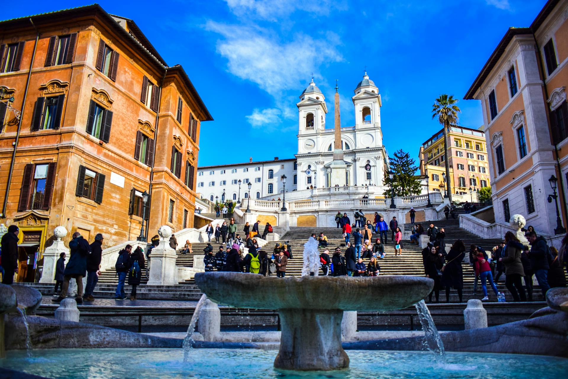 Rome walking tour through a historic square with a baroque fountain in the city centre